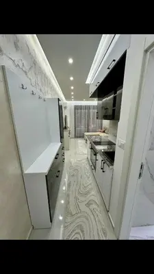 a kitchen with white cabinets and a marble floor at Garsonjera studio in Bar