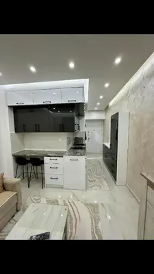a white kitchen with a couch and a table at Garsonjera studio in Bar