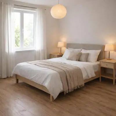 a white bedroom with a large bed with two night stands at Parkside Place in Podgorica