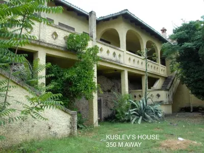 an old house with a staircase in front of it at Parkside Place in Podgorica