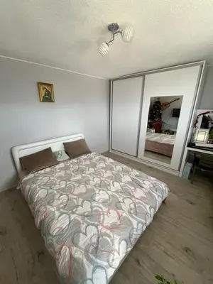 a bedroom with a bed and a mirror at Guest House Fenix