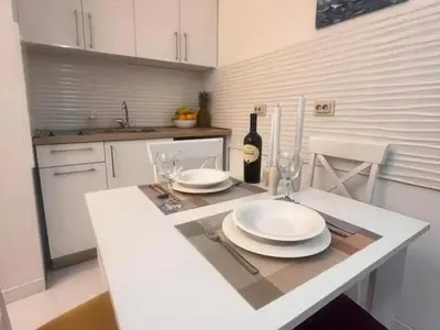 a kitchen with a table with plates and wine glasses at Old town nest in Budva