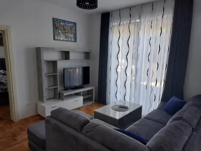 a living room with a couch and a television at Luxury Andrej Apartment with Garage in Polje