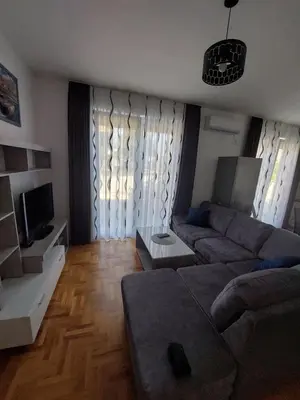 a living room with a couch and a tv at Luxury Andrej Apartment with Garage in Polje