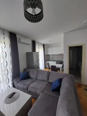 a living room with a couch and a table at Luxury Andrej Apartment with Garage in Polje