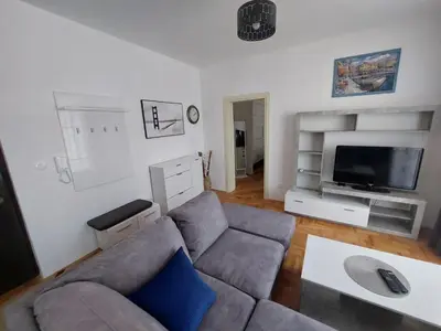 a living room with a couch and a flat screen tv at Luxury Andrej Apartment with Garage in Polje