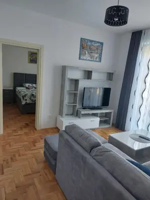 a living room with a couch and a flat screen tv at Luxury Andrej Apartment with Garage in Polje