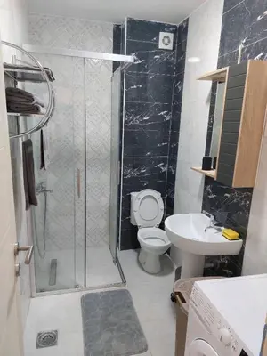 a bathroom with a shower and a toilet and a sink at Luxury Andrej Apartment with Garage in Polje