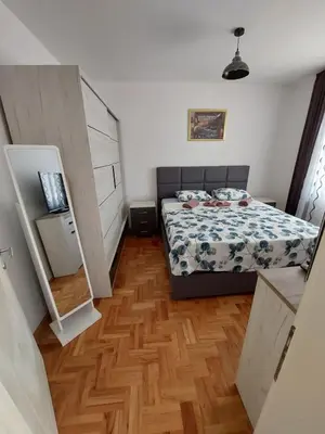 a small bedroom with a bed and a wooden floor at Luxury Andrej Apartment with Garage in Polje
