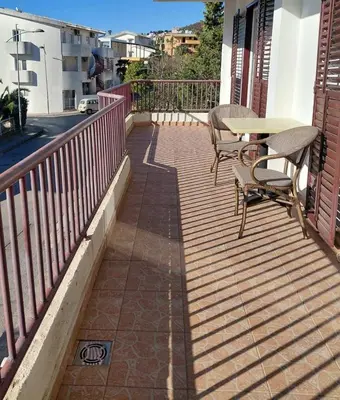 a patio with a table and chairs on a balcony at Apartment Maruni in Bar, Susanj