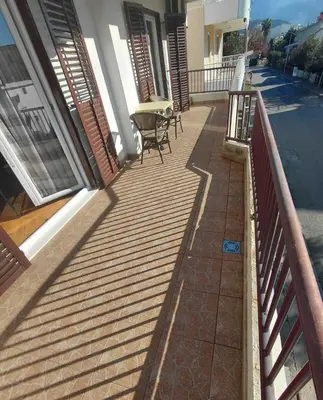 a balcony with a table and chairs on a house at Apartment Maruni in Bar, Susanj