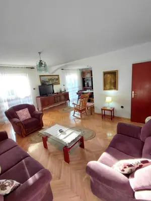 a living room with purple couches and a coffee table at Apartment Maruni in Bar, Susanj