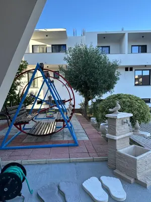 a playground in front of a building at REXHEPI Apartments in Ulcinj