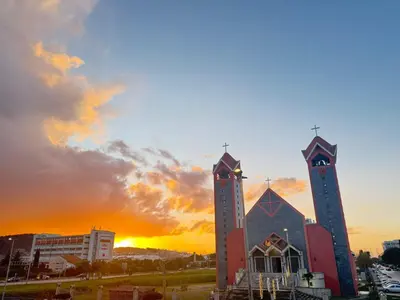 a church with two towers with the sunset in the background at BAR - Jednosoban stan u centru in Bar