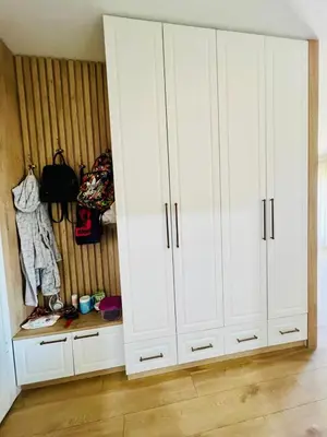 a white closet with white cabinets in a room at BAR - Jednosoban stan u centru in Bar