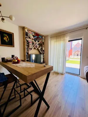 a living room with a wooden table in a room at BAR - Jednosoban stan u centru in Bar