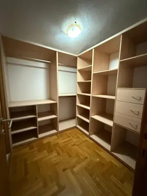 an empty closet with shelves and a light on the ceiling at Vila Žuta in Bar