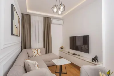 a living room with a couch and a tv at Deluxe Apartment Zarah in Bar