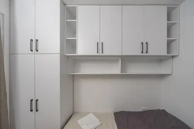 a room with white cabinets and a bed at Deluxe Apartment Zarah in Bar