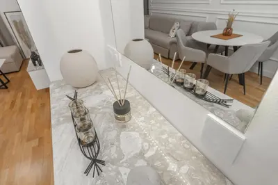 a living room with a couch and a table with chairs at Deluxe Apartment Zarah in Bar