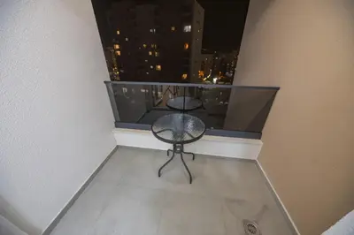 a balcony with a table and chairs on a balcony at Deluxe Apartment Zarah in Bar