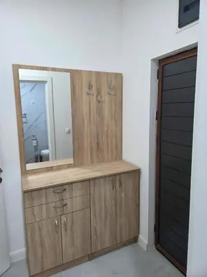 a wooden dresser with a mirror in a bathroom at Zara in Bar