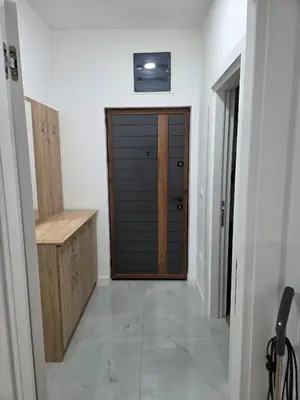 a hallway with a closet with a wooden door at Zara in Bar