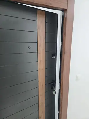 ajar door of a garage with a wooden handle at Zara in Bar