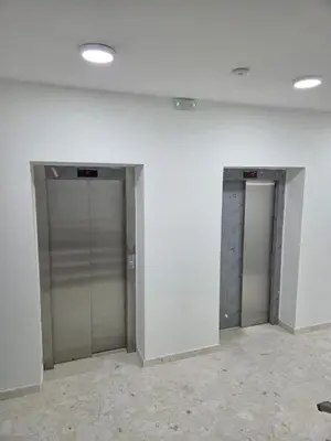 two elevators in a room with white walls at Zara in Bar
