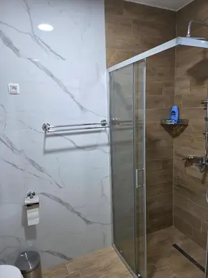 a shower with a glass door in a bathroom at Zara in Bar