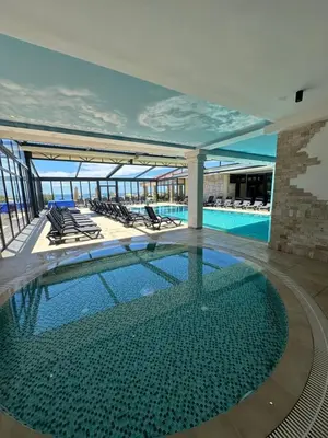a swimming pool on the top of a building at Hotel SPICH Biserna Obala Čanj in Čanj