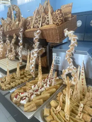 a display of bread and pastries in a bakery at Hotel SPICH Biserna Obala Čanj in Čanj