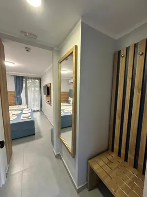 a room with two beds and a mirror at Hotel SPICH Biserna Obala Čanj in Čanj