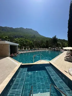 a large swimming pool with blue water at Hotel SPICH Biserna Obala Čanj in Čanj