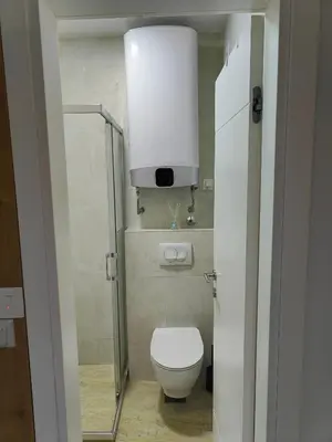 a small bathroom with a toilet and a light at Apartment Montenegro Becici in Becici