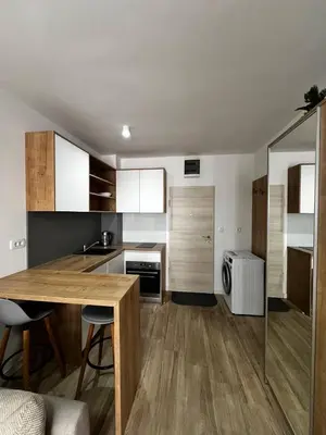 a kitchen with a wooden table in a room at Apartment Montenegro Becici in Becici