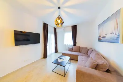 a living room with a couch and a table at Lamadu Residence in Sutomore