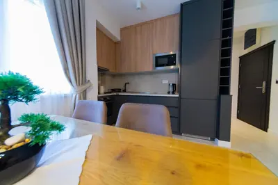 a kitchen and dining room with a table and chairs at Lamadu Residence in Sutomore