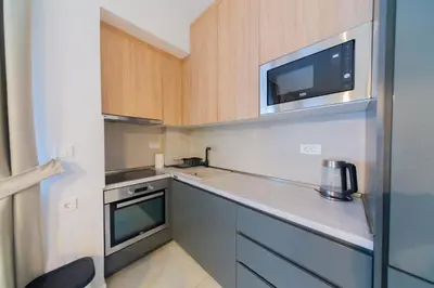 a small kitchen with a sink and a microwave at Lamadu Residence in Sutomore