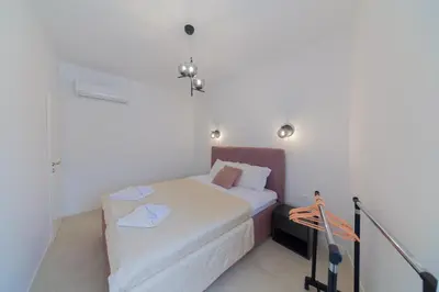 a small bedroom with a bed and a chandelier at Lamadu Residence in Sutomore