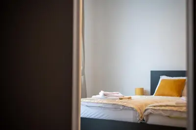 a bedroom with a bed with a yellow pillow at Lamadu Residence in Sutomore