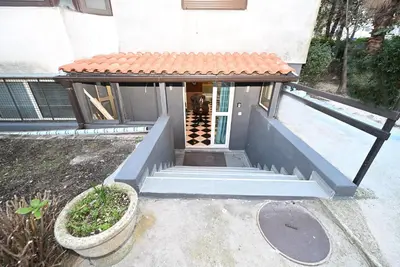 a small house with a staircase leading to a door at Vintage apartment in Kotor