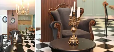 a living room with a chair and a table with candles at Vintage apartment in Kotor
