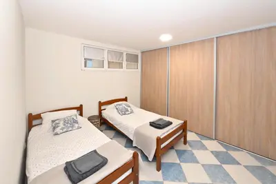 a small room with two beds and a closet at Vintage apartment in Kotor