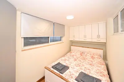 a small bedroom with a bed and a window at Vintage apartment in Kotor