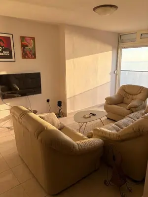 a living room with two couches and a tv at 50 Shades of Blue in Ulcinj