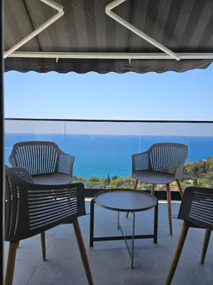 two chairs and a table in front of a window at 50 Shades of Blue in Ulcinj