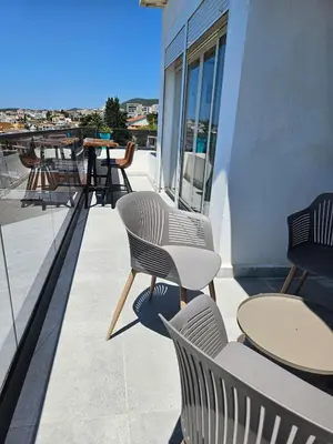 a patio with tables and chairs on a balcony at 50 Shades of Blue in Ulcinj