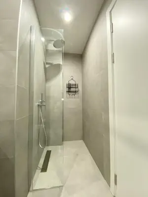 a shower with a glass door in a bathroom at AZZURRO BAR Apartment in Bar