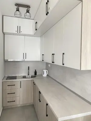 a kitchen with white cabinets and a sink at AZZURRO BAR Apartment in Bar